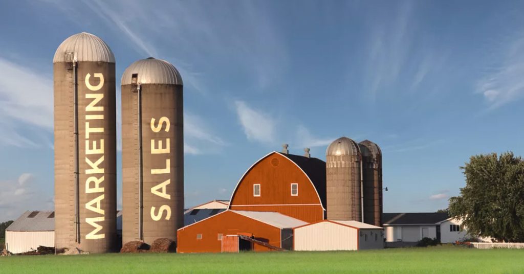 Red farm house with two silos, representing the silos between sales and marketing. Digital Transformation experts are proficient at breaking down these silos and leading you through a smooth Digital Transformation Journey and mitigating Digital Transformation Risks along the way.